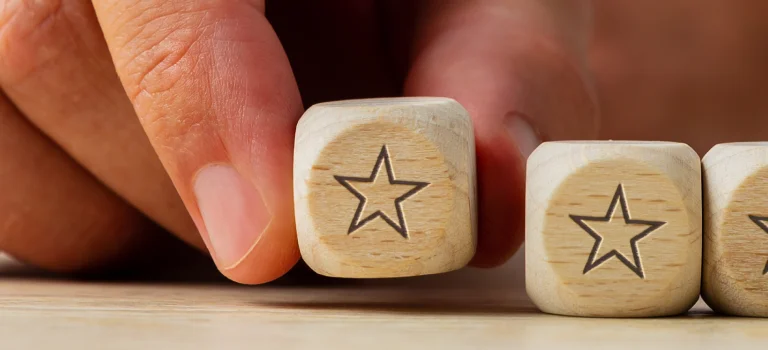 a pair of wooden dice with stars engraved on them
