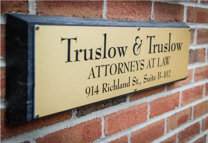a sign on a brick wall