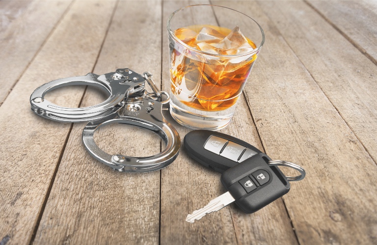 Whiskey with car keys and handcuffs