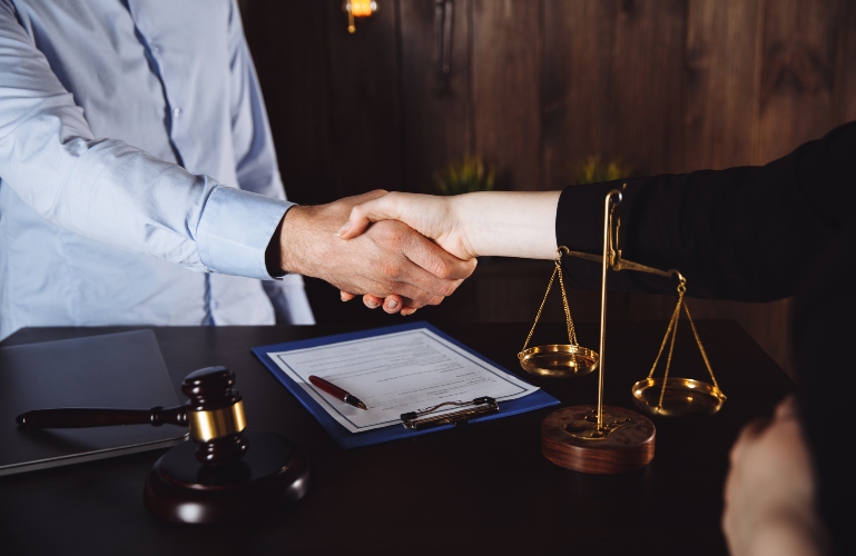 client shaking hands with lawyer