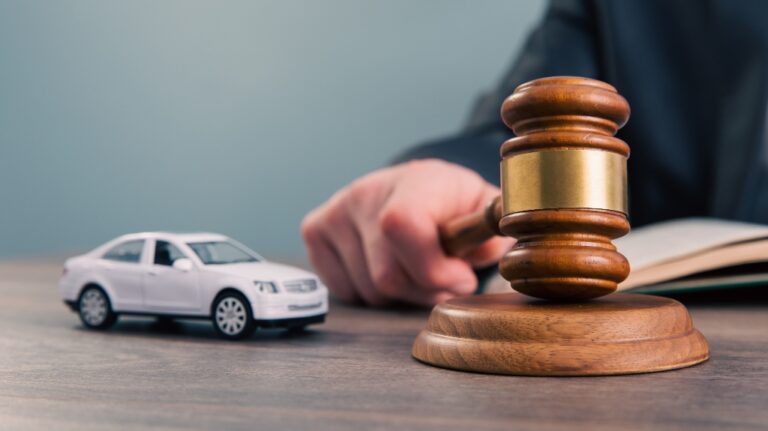 Model of car and gavel