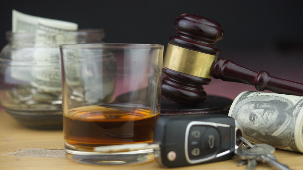 Judge's gavel and whiskey glass, car key