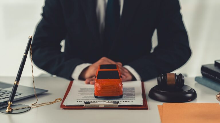 Lawyer with toy car and judge's gavel