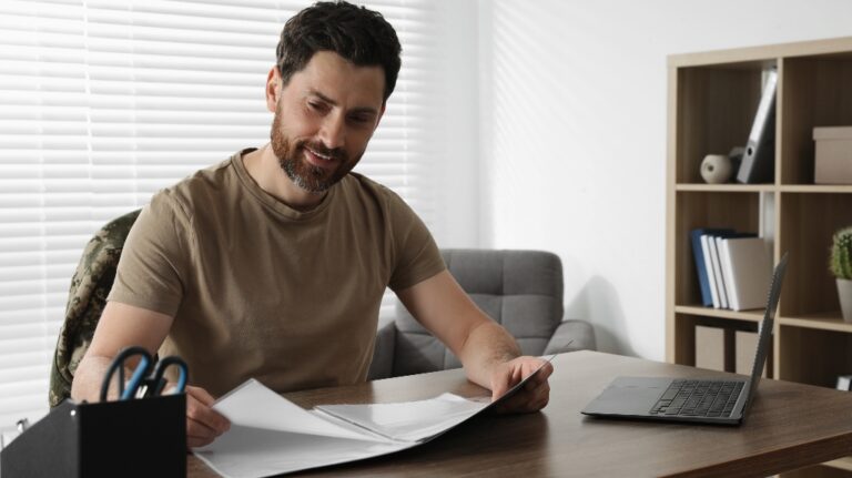 Military man is looking at the documents