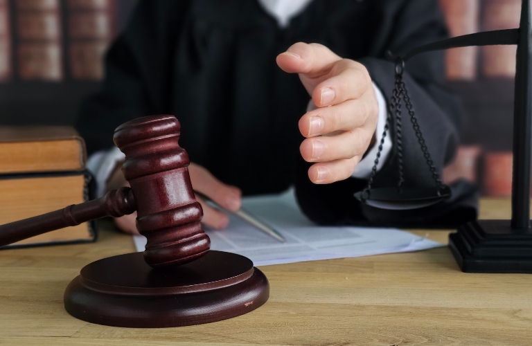 Judge holding a gavel in a courtroom