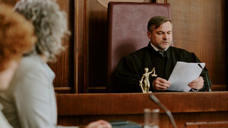 man judge reading legal documents in courtroom