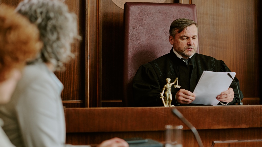 man judge reading legal documents in courtroom