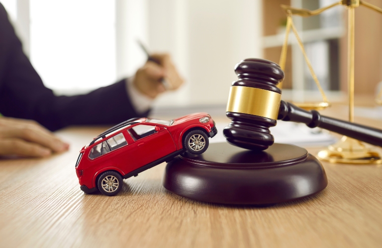 toy automobile on table with sound block and gavel